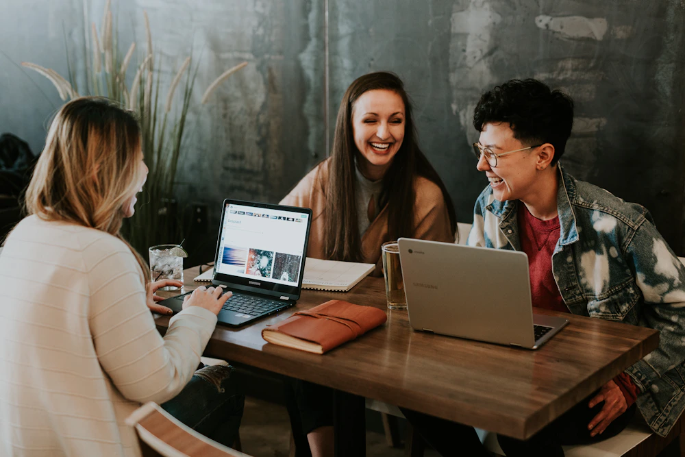 Young adults sharing ideas around a table