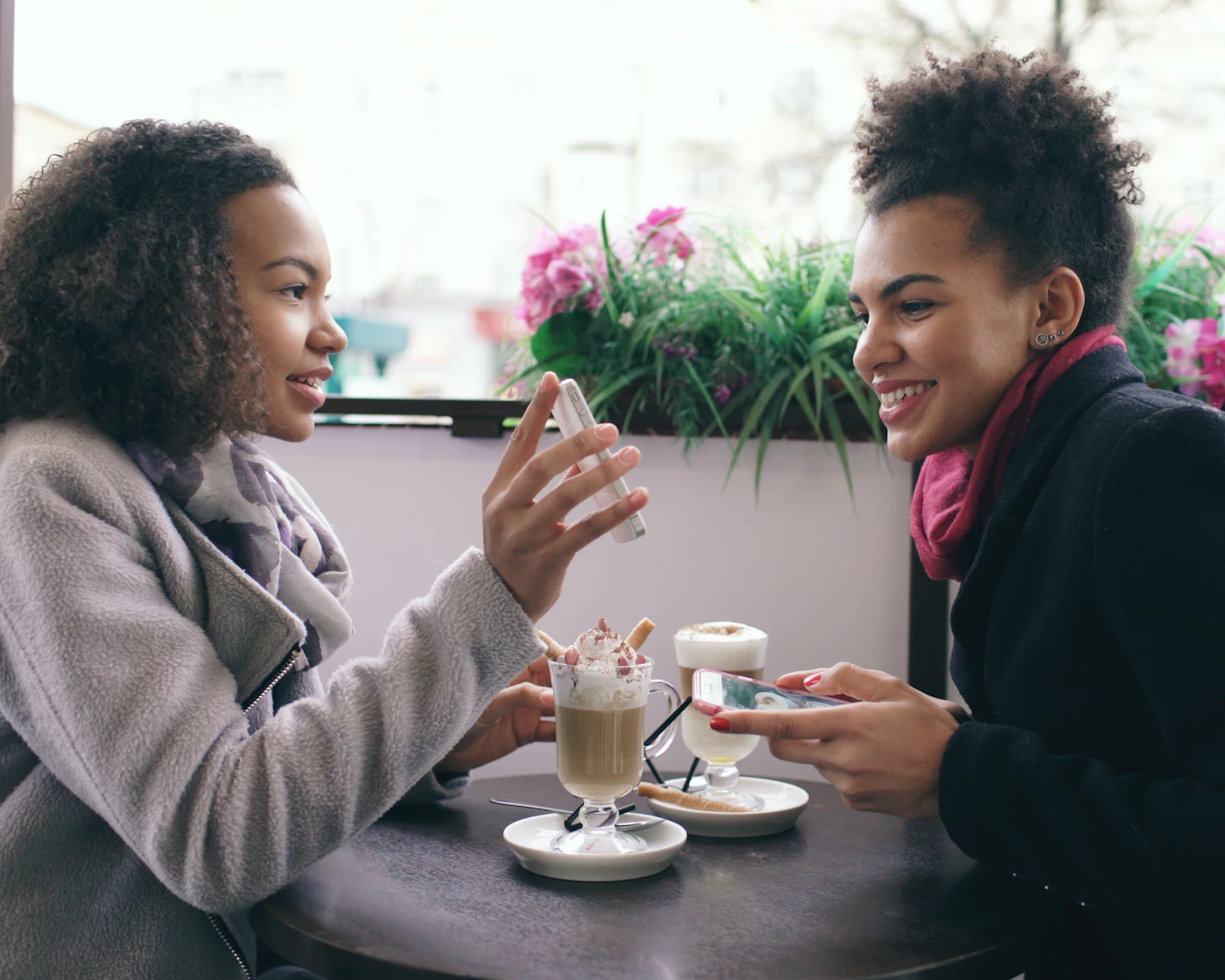 Two young adults having a conversation at a cafe