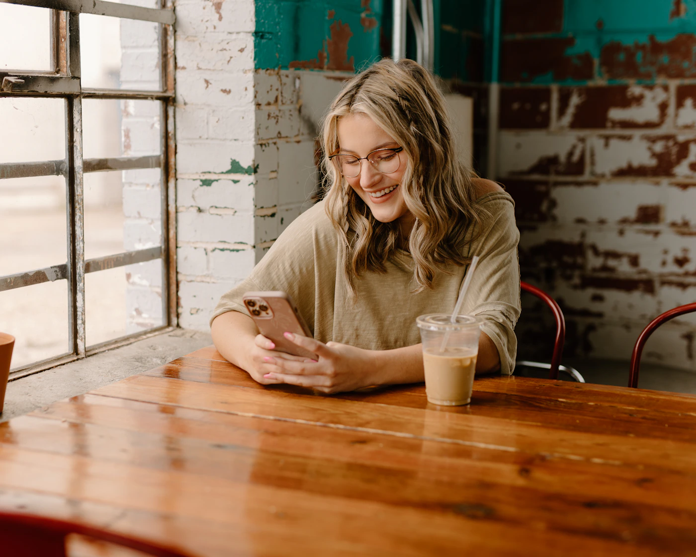 A woman using her phone in a relaxed cafe setting